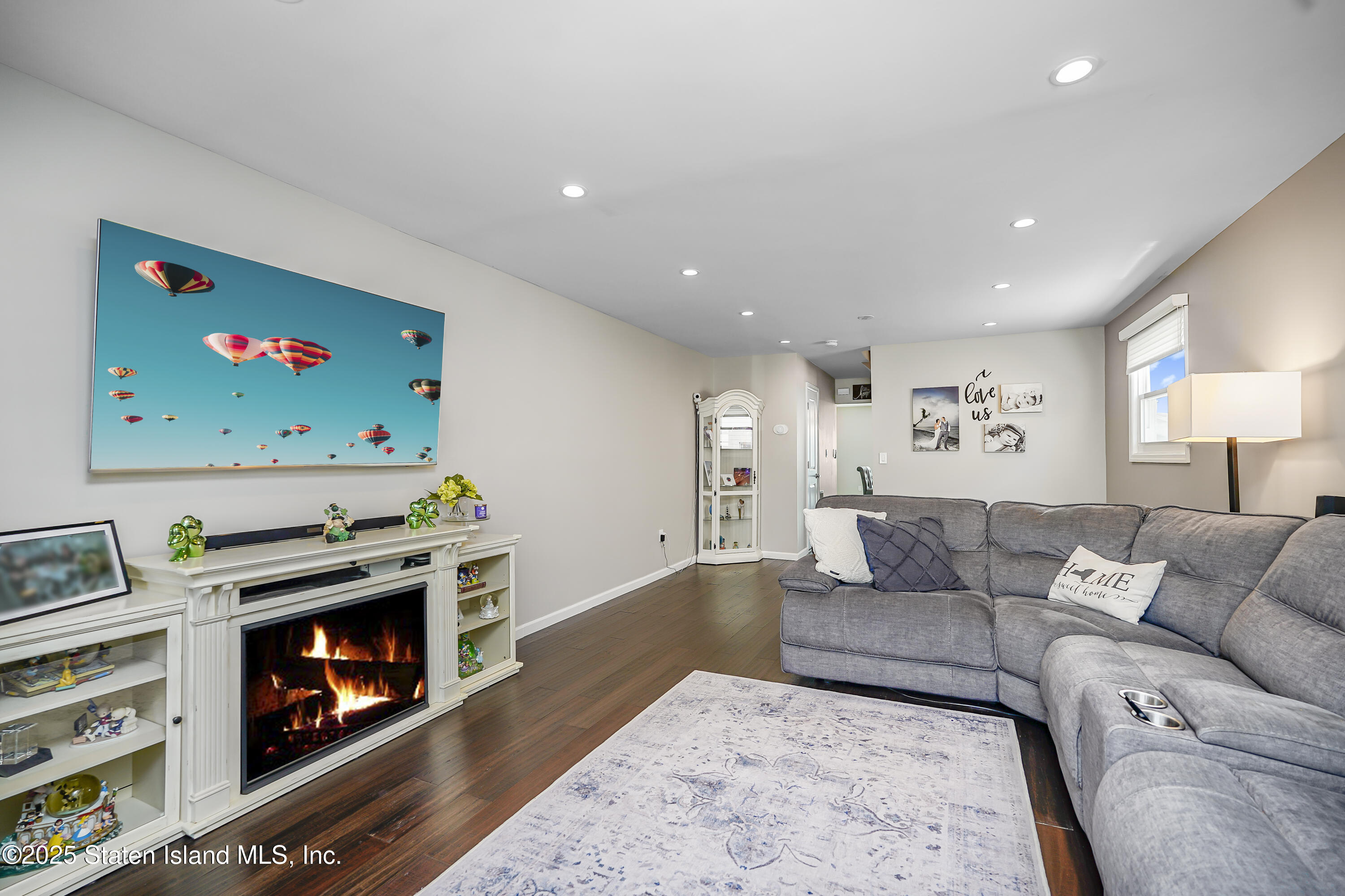 994 Rensselaer Avenue Staten Island, NY 10309 - Photo 3 of 34 a living room with furniture and a fireplace