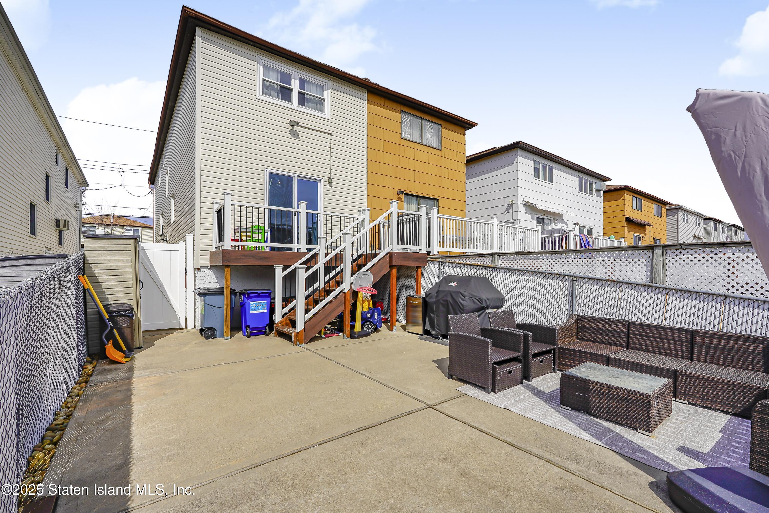 994 Rensselaer Avenue Staten Island, NY 10309 - Photo 31 of 34 a view of a house with large windows and furniture