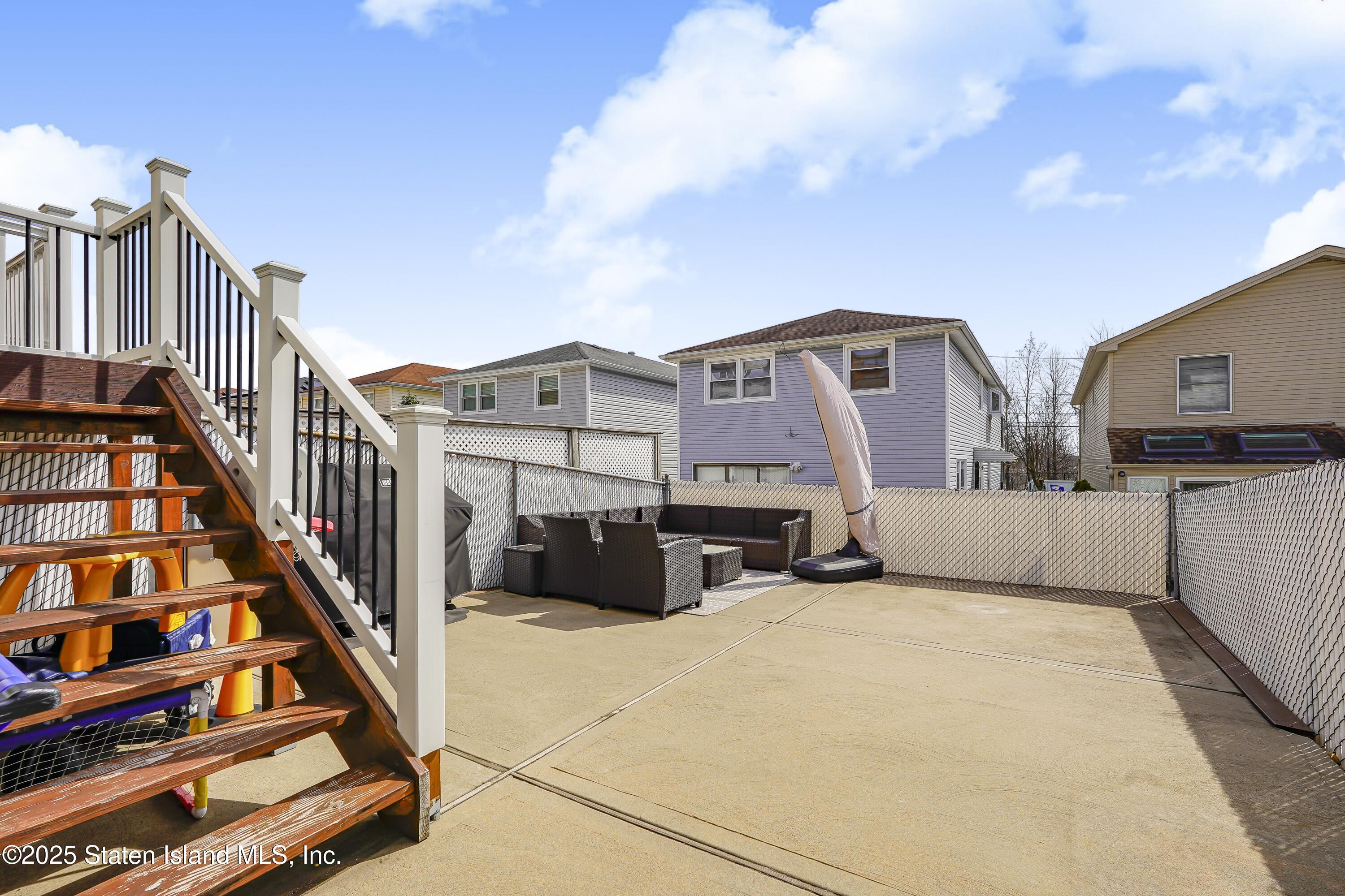994 Rensselaer Avenue Staten Island, NY 10309 - Photo 32 of 34 a view of a building with barbeque grill and couches