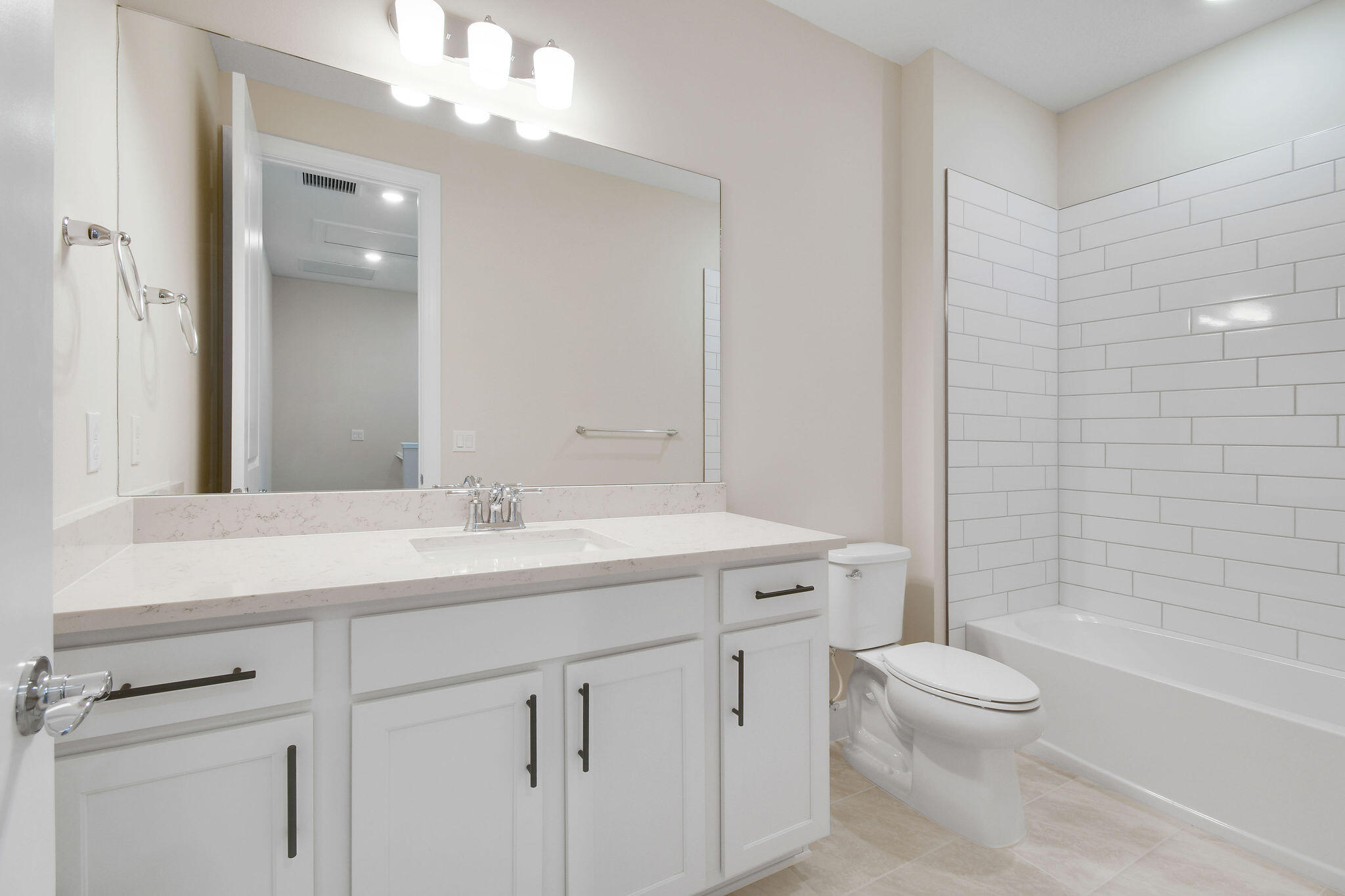 7798 Southwest Bentley Lane, Unit LATITUDE 8316 Stuart, FL 34997 - Photo 13 of 21 a bathroom with a sink a toilet and shower