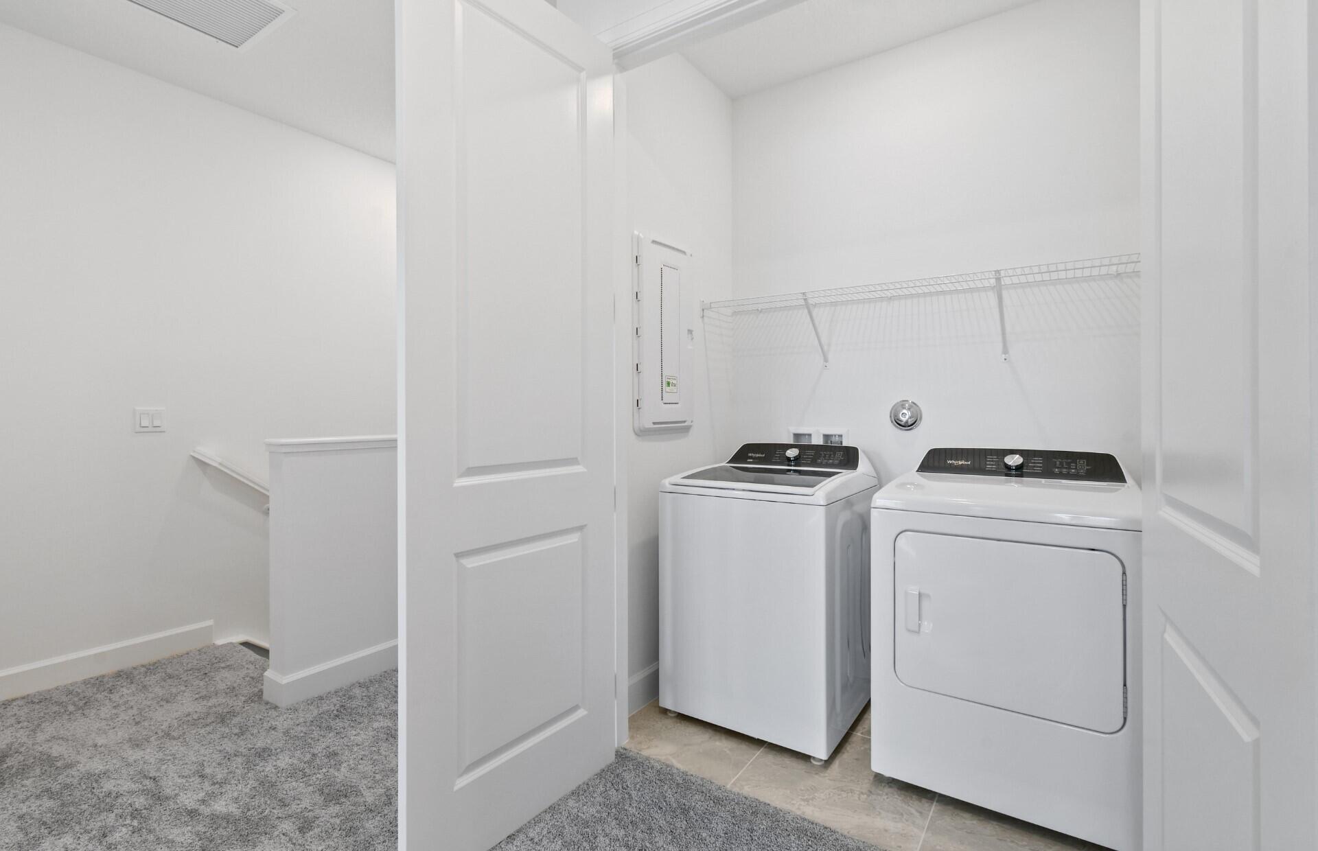 7798 Southwest Bentley Lane, Unit LATITUDE 8316 Stuart, FL 34997 - Photo 14 of 21 a view of storage and utility room with washer and dryer