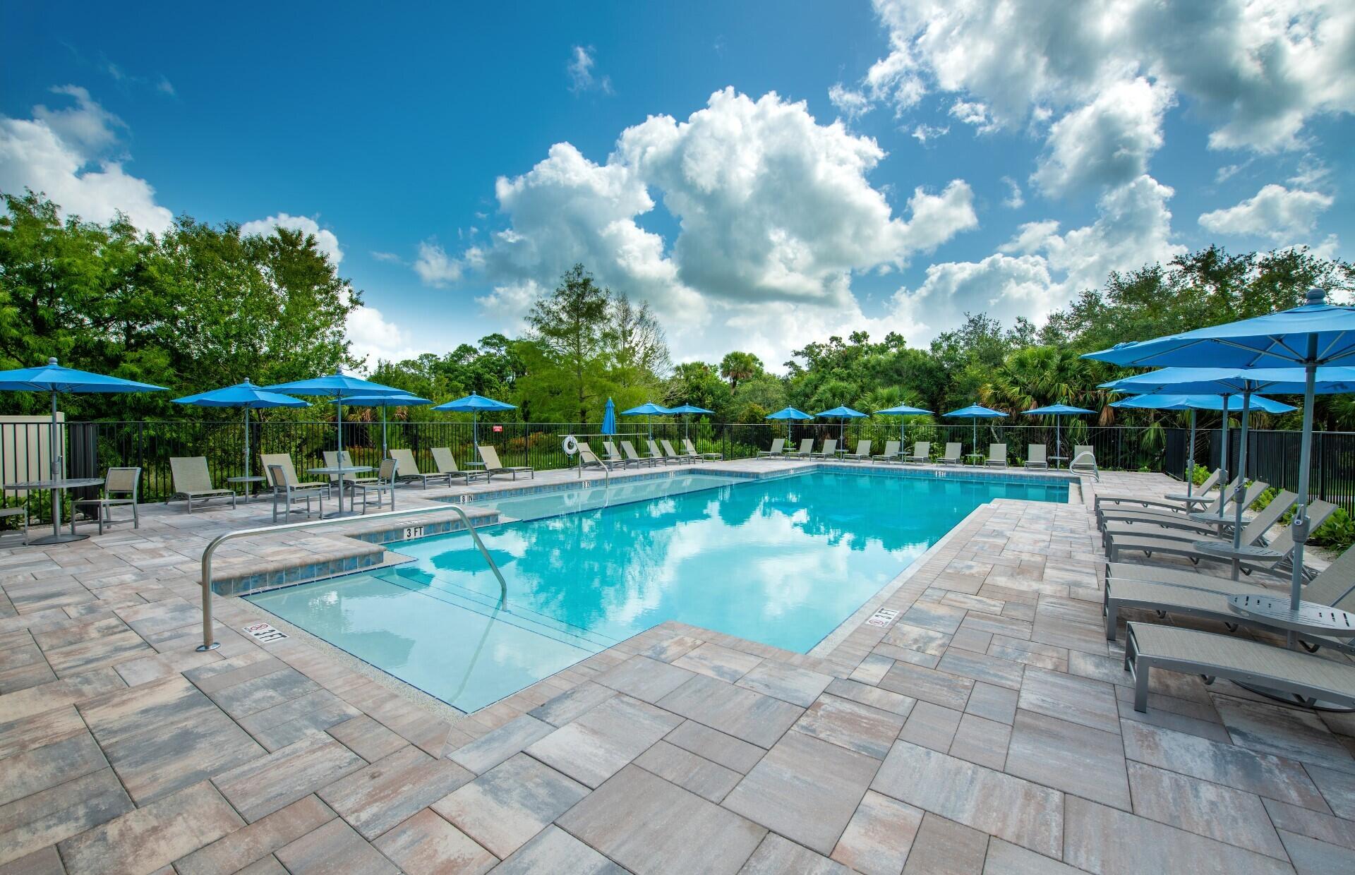 7798 Southwest Bentley Lane, Unit LATITUDE 8316 Stuart, FL 34997 - Photo 17 of 21 a view of a swimming pool with a patio