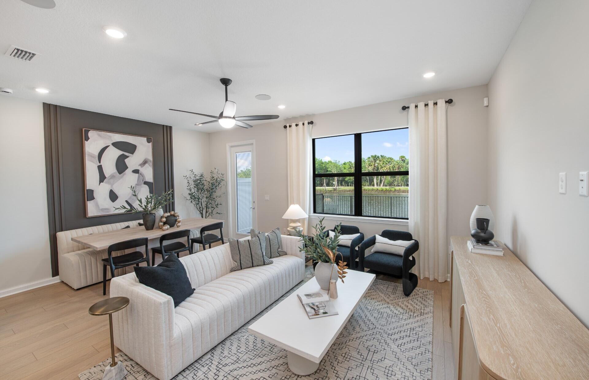 7798 Southwest Bentley Lane, Unit LATITUDE 8316 Stuart, FL 34997 - Photo 6 of 21 a living room with furniture and a large window