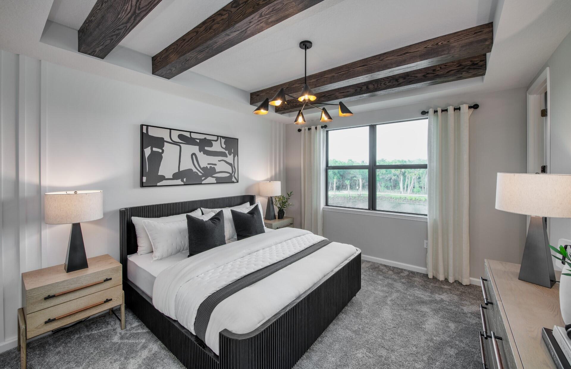 7798 Southwest Bentley Lane, Unit LATITUDE 8316 Stuart, FL 34997 - Photo 8 of 21 a bedroom with a bed and a lamp