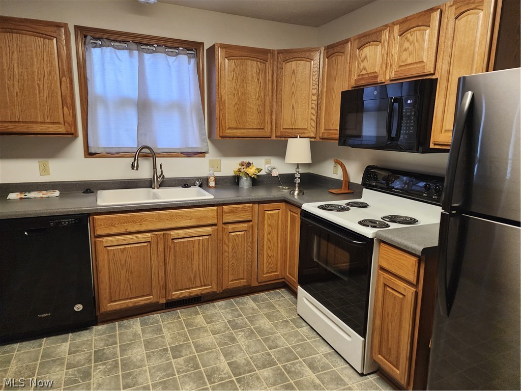 176 Overhill Road Youngstown, OH 44512 - Photo 8 of 20 Kitchen with dishwashing machine, sink, stove, refrigerator, and light tile floors