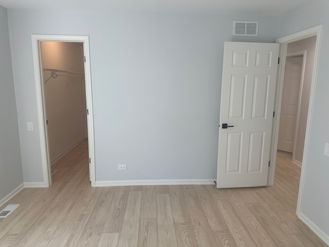 1311 Blue Ridge Parkway Algonquin, IL 60102 - Photo 15 of 21 an empty room with wooden floor and closet area