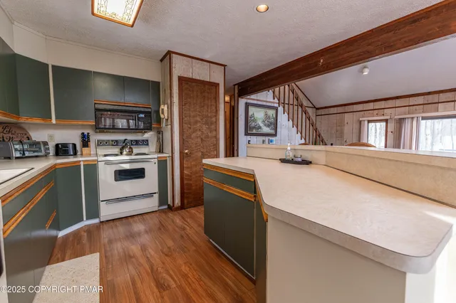 a kitchen with stainless steel appliances granite countertop a stove and a refrigerator