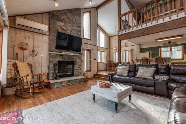 a living room with furniture fireplace and flat screen tv