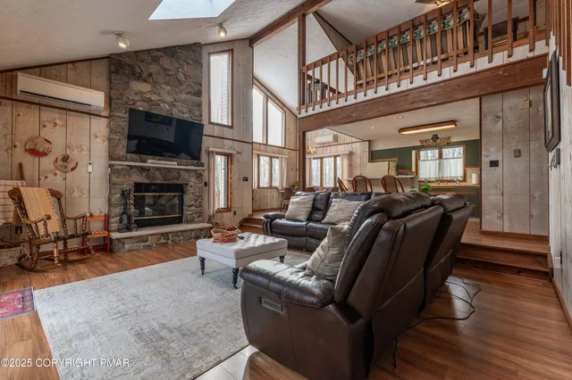 a living room with fireplace furniture and a flat screen tv