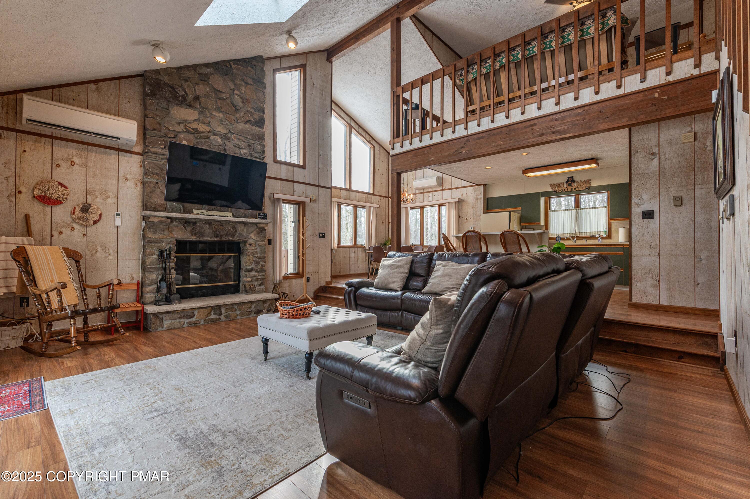178 Cardinal Drive, Unit R2108 Gouldsboro, PA 18424 - Photo 16 of 58 a living room with furniture a fireplace and a flat screen tv