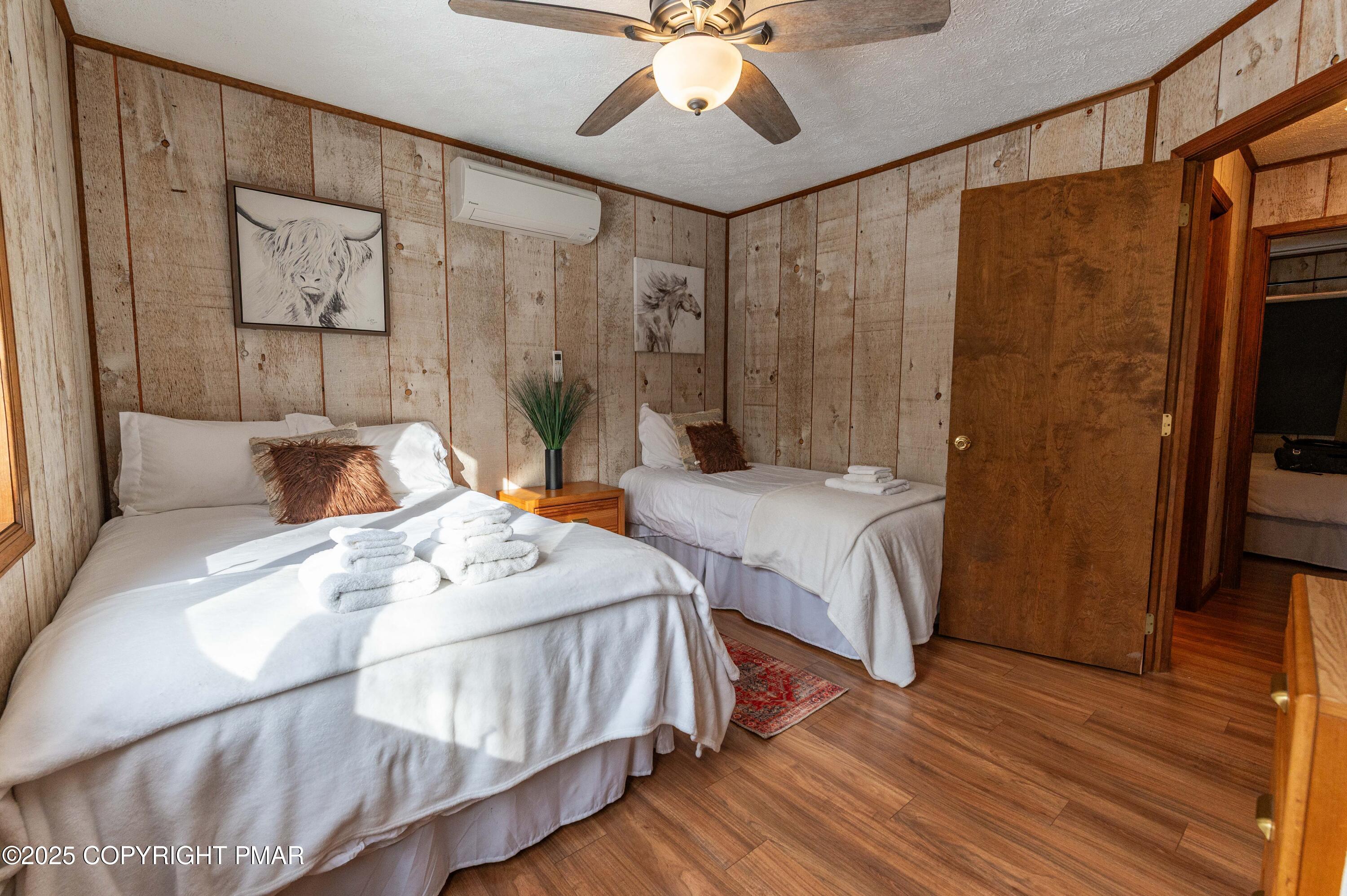 178 Cardinal Drive, Unit R2108 Gouldsboro, PA 18424 - Photo 20 of 58 a bedroom with double bed and a chandelier