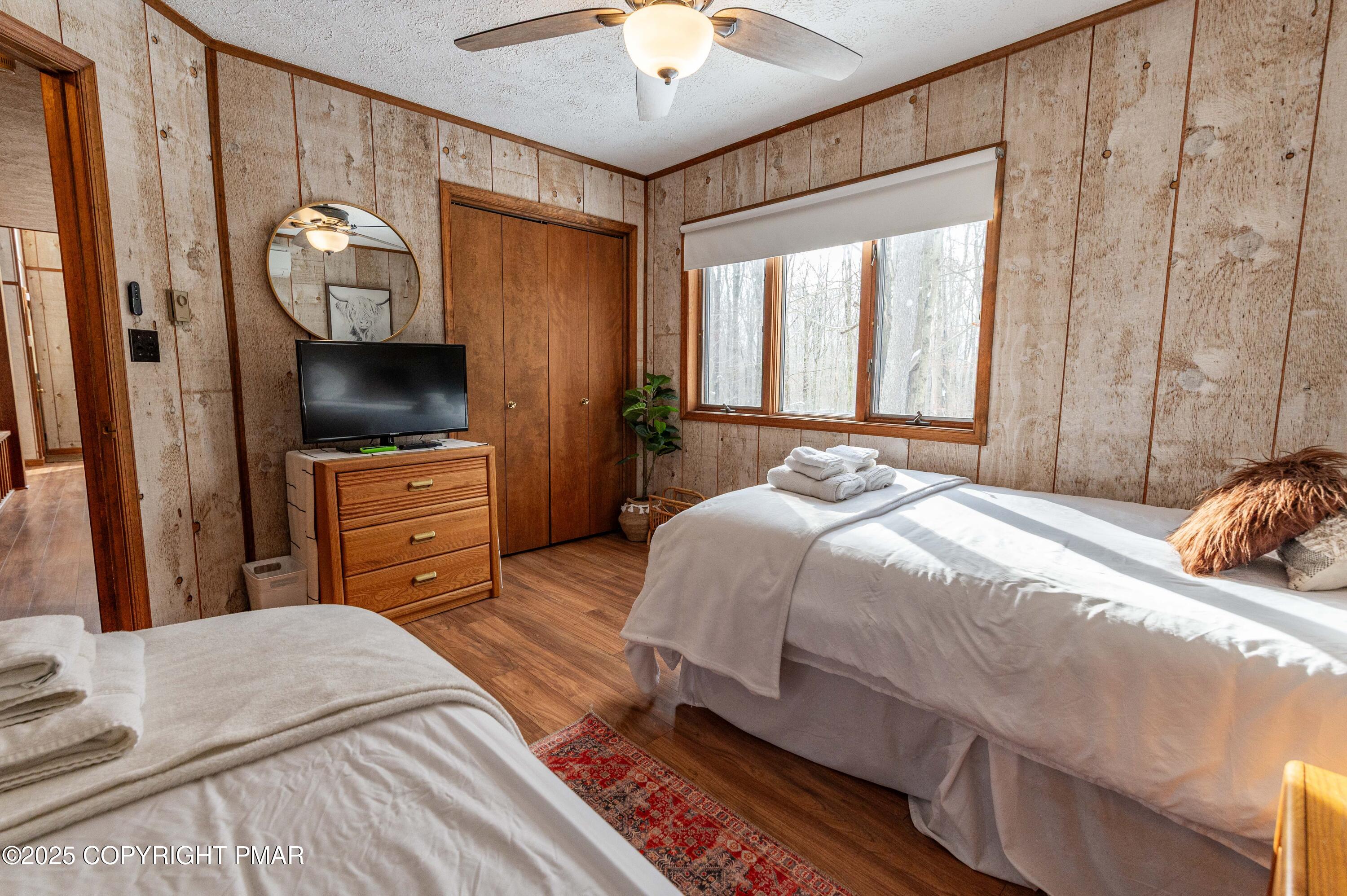 178 Cardinal Drive, Unit R2108 Gouldsboro, PA 18424 - Photo 22 of 58 a bedroom with a bed and a flat tv screen on dresser