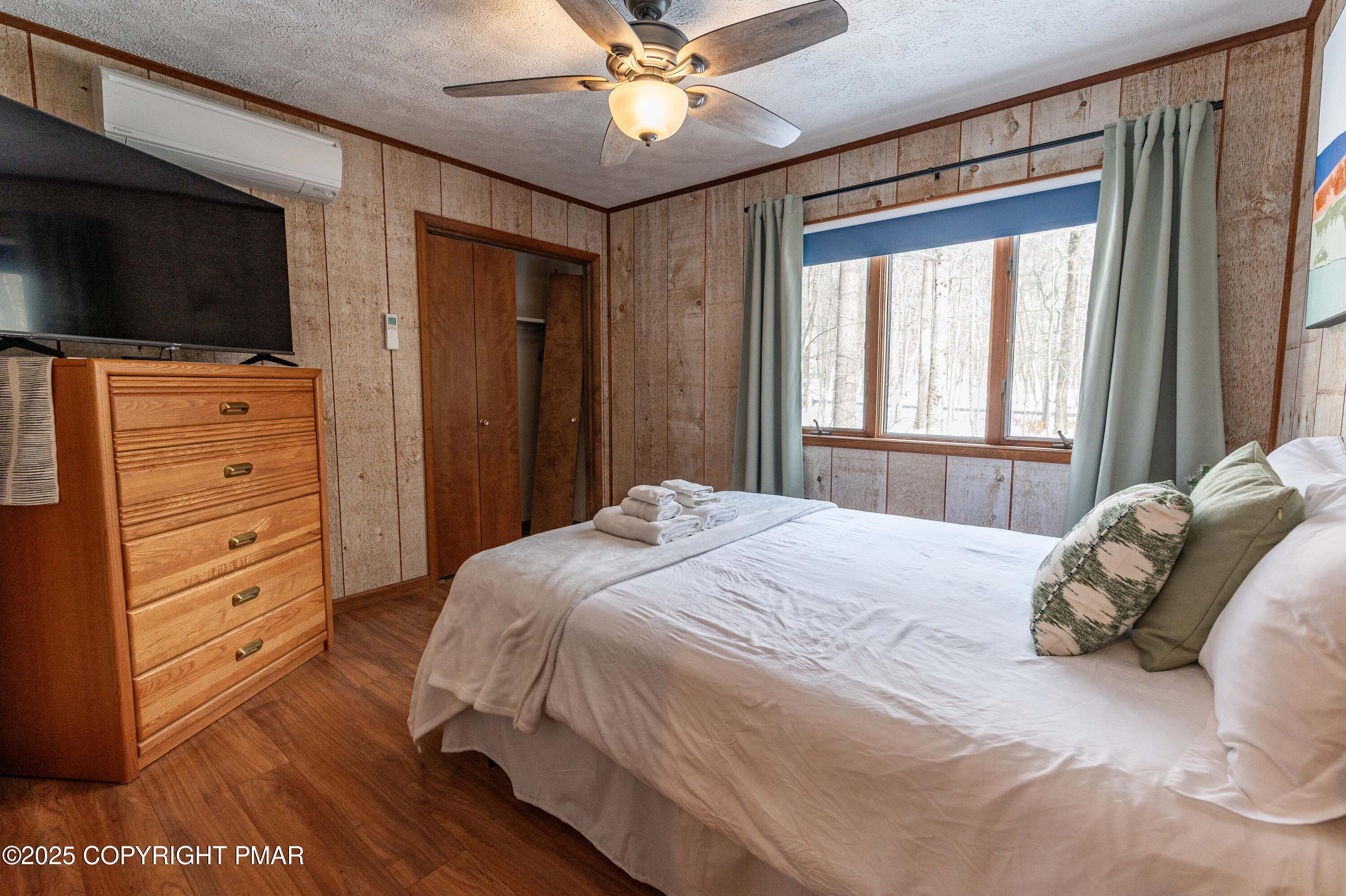 178 Cardinal Drive, Unit R2108 Gouldsboro, PA 18424 - Photo 23 of 58 a bedroom with a bed and a flat screen tv