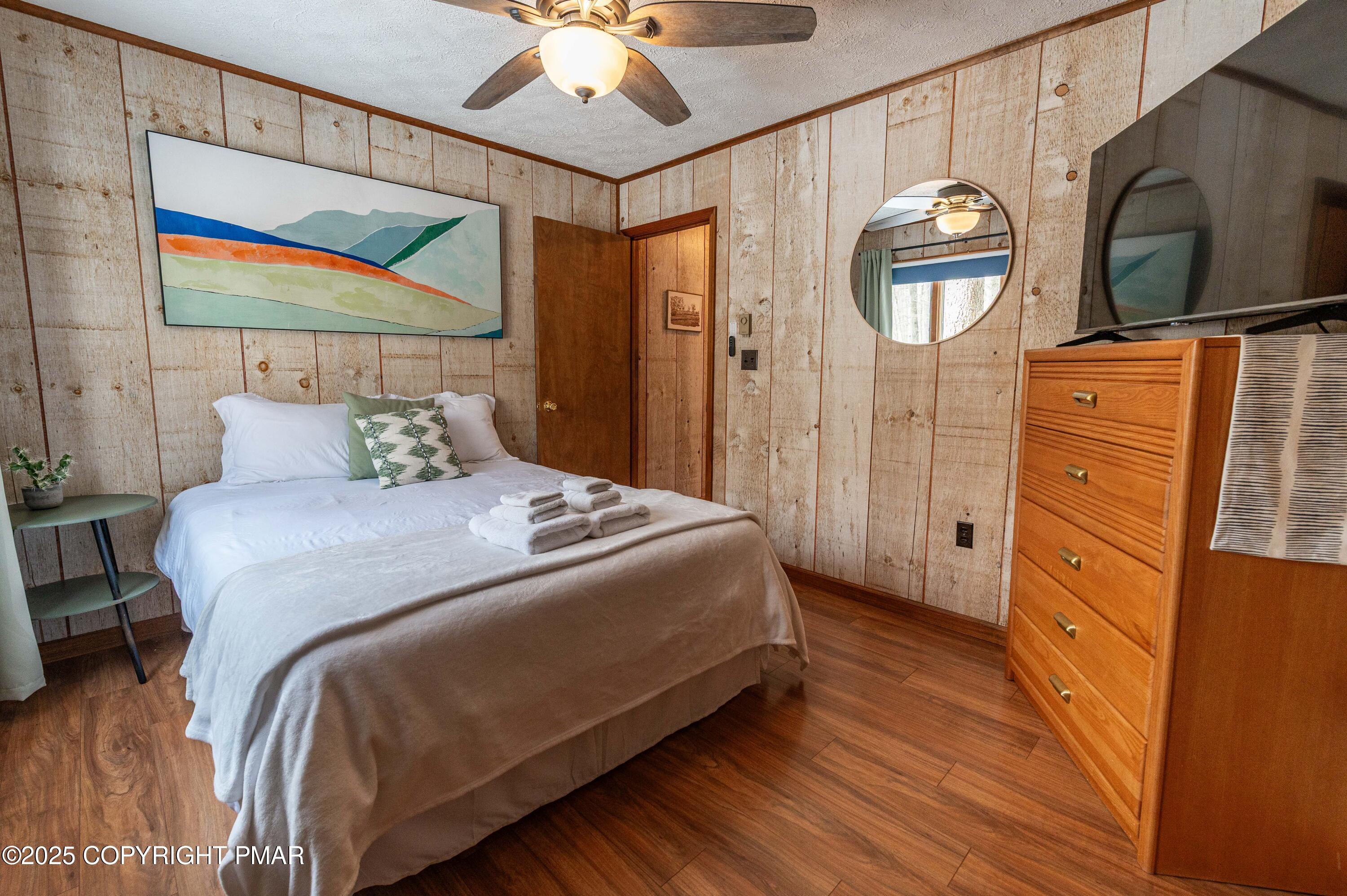 178 Cardinal Drive, Unit R2108 Gouldsboro, PA 18424 - Photo 24 of 58 a bedroom with a bed a dresser and painting on the wall