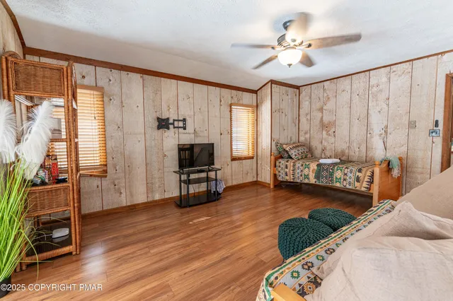 a bedroom with a bed mirror and a window