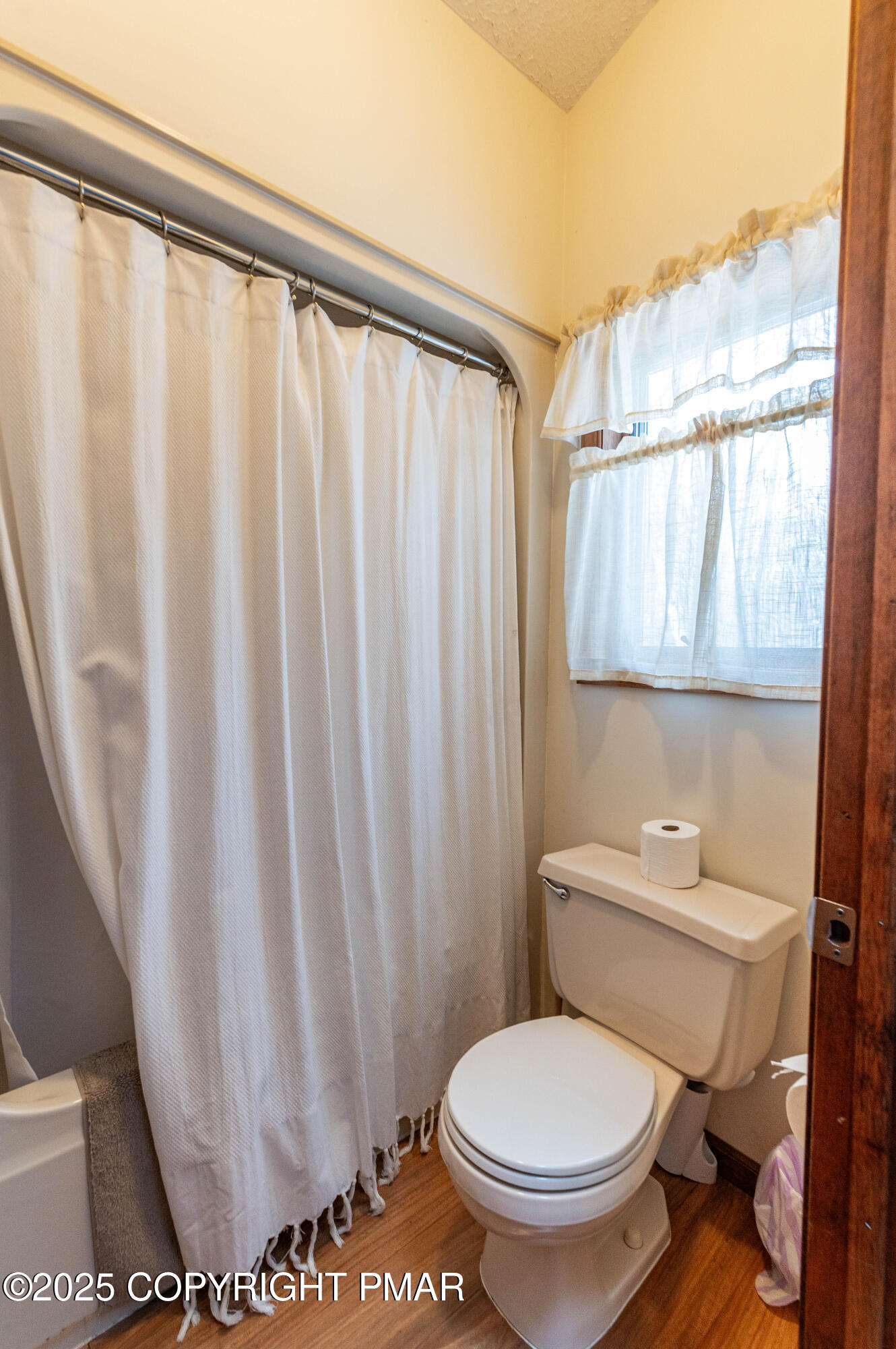 178 Cardinal Drive, Unit R2108 Gouldsboro, PA 18424 - Photo 36 of 58 a white toilet sitting next to a shower curtain