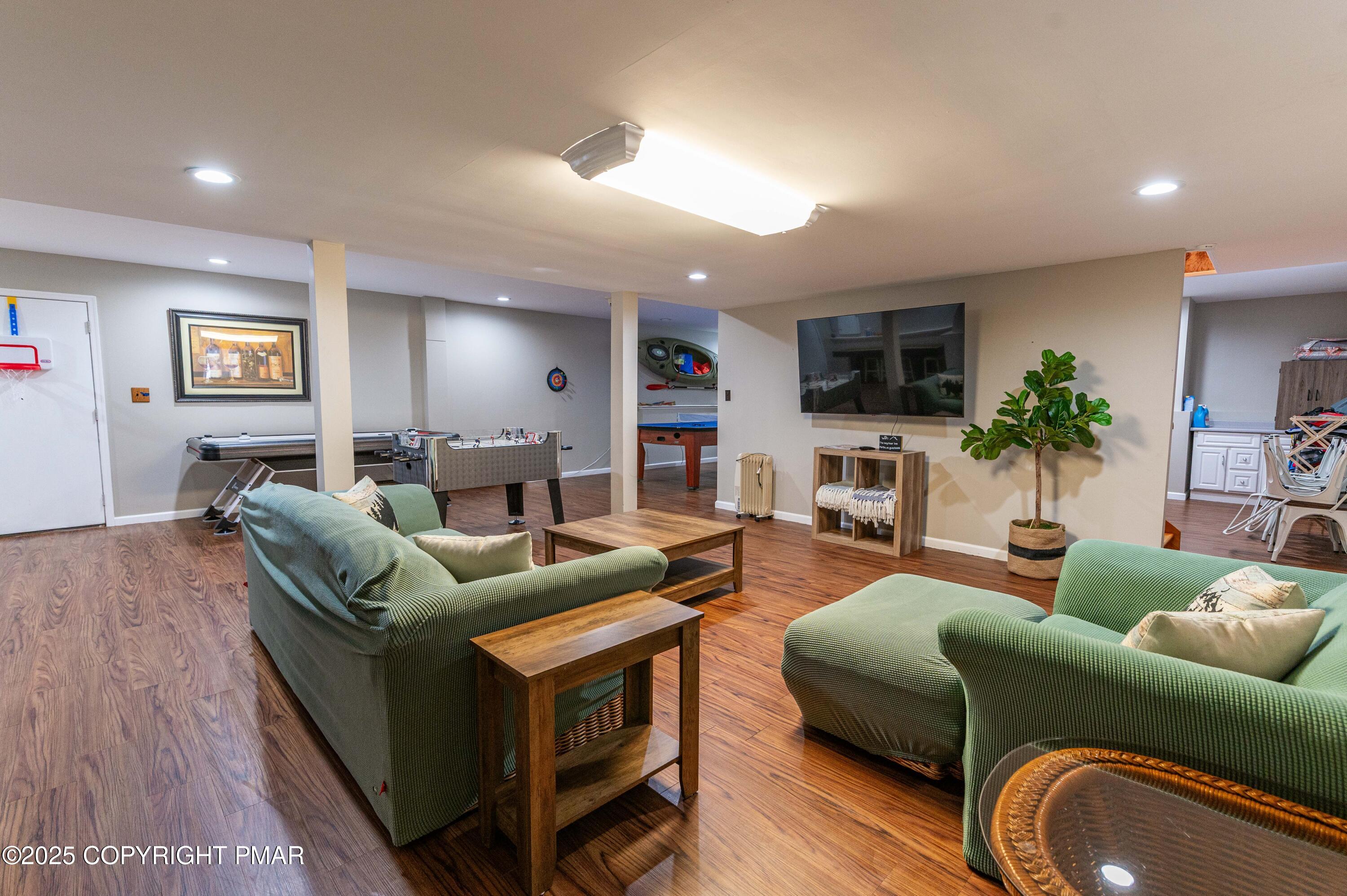 178 Cardinal Drive, Unit R2108 Gouldsboro, PA 18424 - Photo 39 of 58 a living room with furniture a flat screen tv and a fireplace
