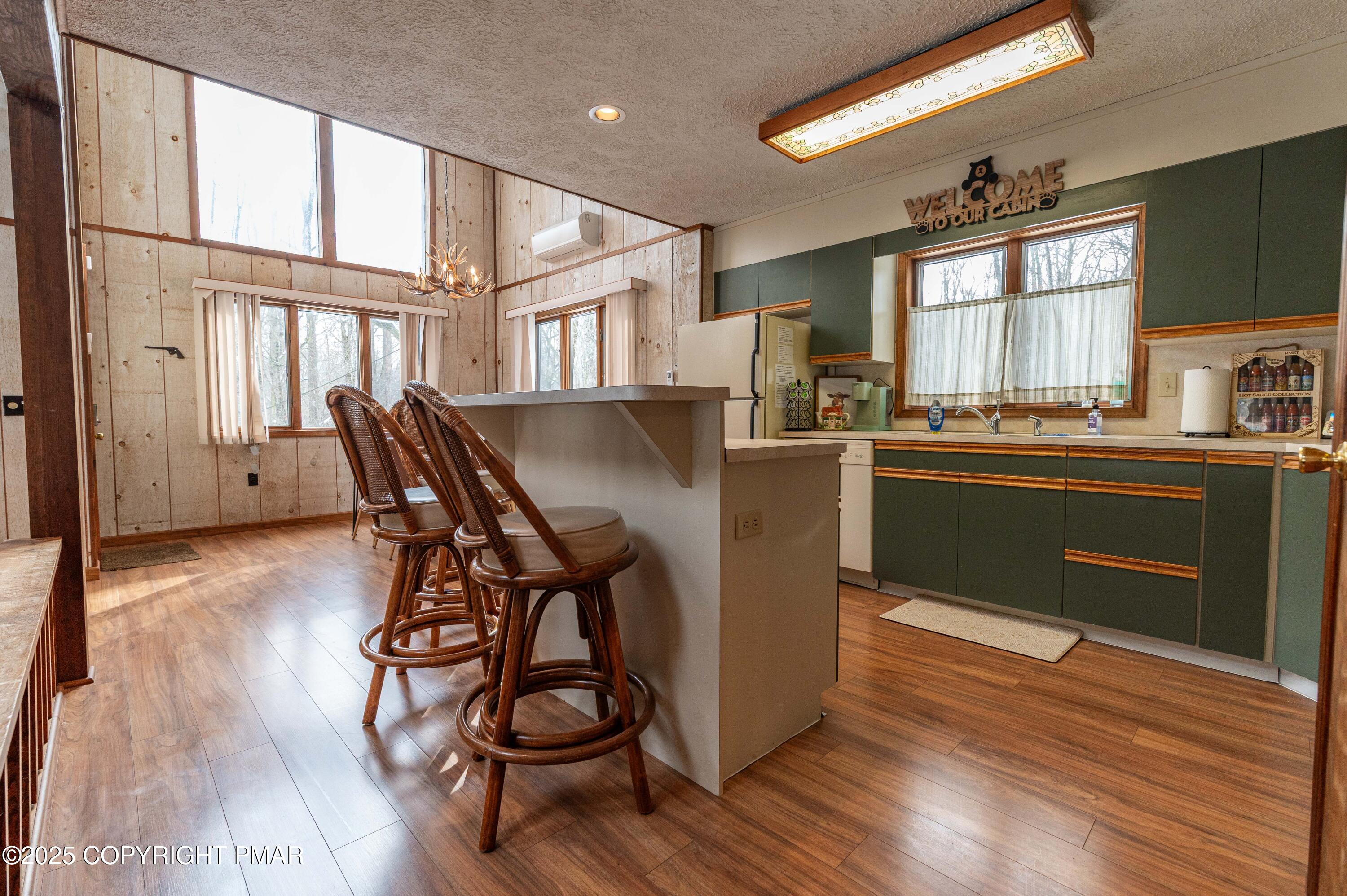 178 Cardinal Drive, Unit R2108 Gouldsboro, PA 18424 - Photo 8 of 58 a kitchen with stainless steel appliances granite countertop a stove a sink dishwasher and a refrigerator with wooden floor