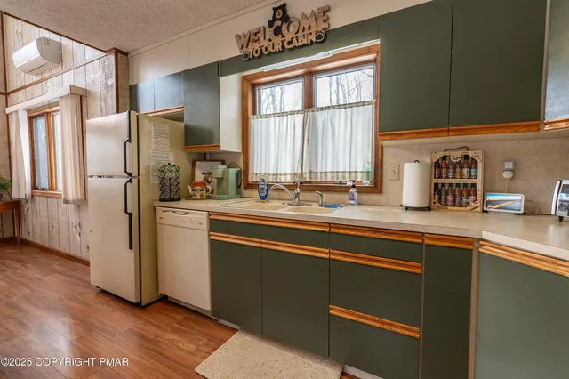 a kitchen with a stove a sink and a refrigerator