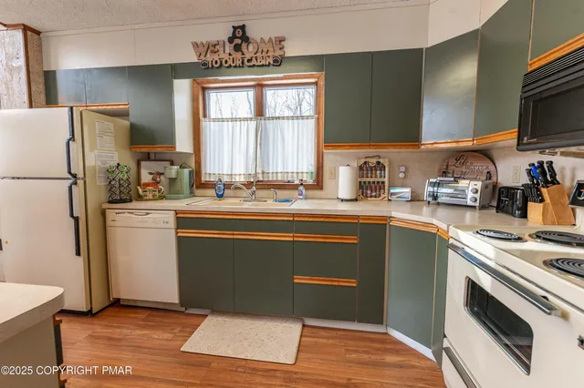a kitchen with stainless steel appliances a stove and a refrigerator