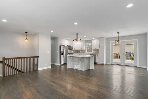 a view of kitchen with stainless steel appliances refrigerator oven and cabinets