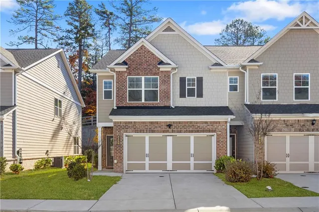 a front view of a house with a garden