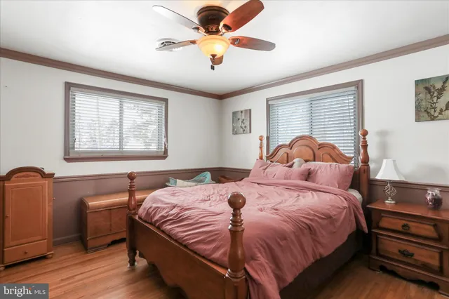 a bedroom with furniture and a large window