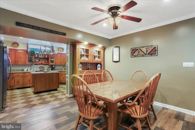 a view of a house with table and chairs under an umbrella