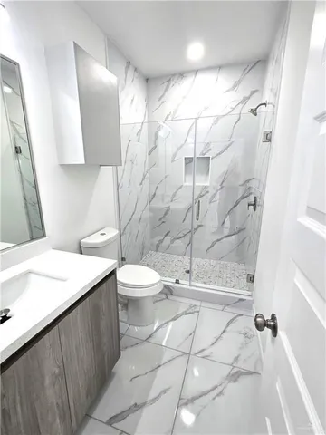 a bathroom with a sink toilet and shower