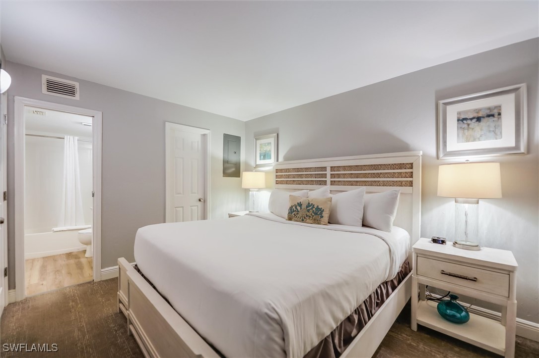 2117 Gulf Beach Villas Captiva, FL 33924 - Photo 14 of 24 a bedroom with a bed and a lamp on the dresser