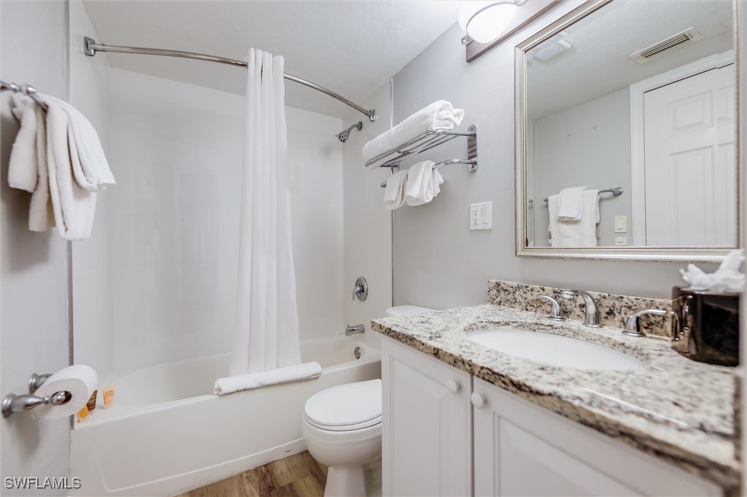 2117 Gulf Beach Villas Captiva, FL 33924 - Photo 16 of 24 a bathroom with a granite countertop sink toilet and shower