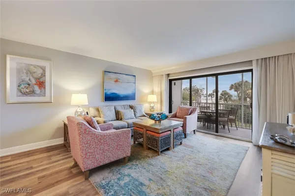 a bedroom with furniture and large windows