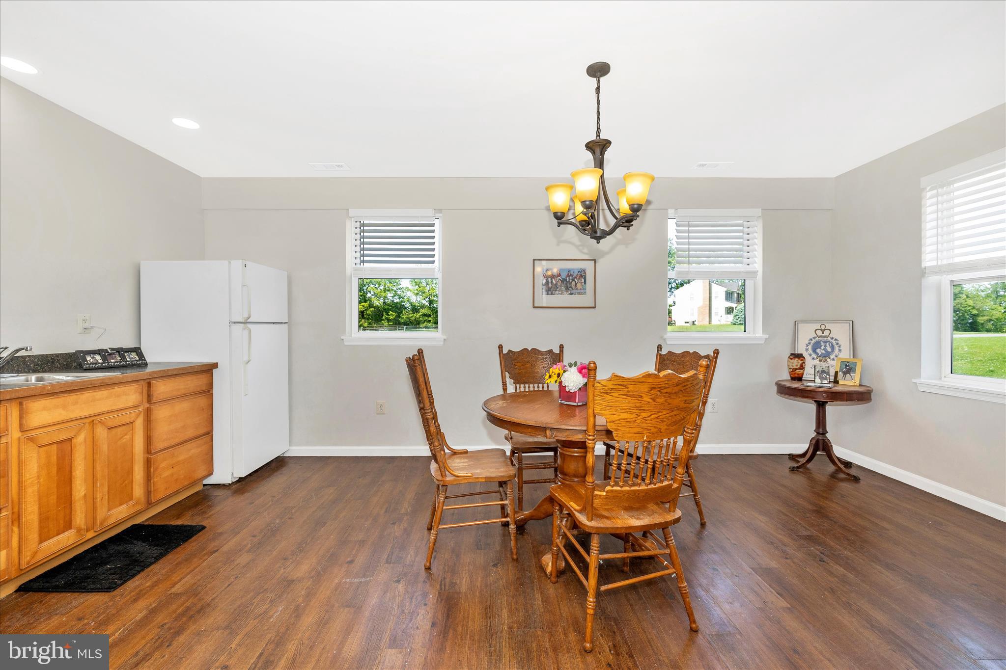 10224 Bessie Clemson Road Union Bridge, MD 21791 - Photo 21 of 46 a dining room with wooden floor a chandelier a wooden table and chairs