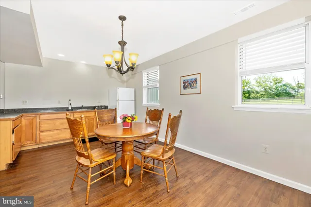a view of a dining room with furniture window and wooden floor