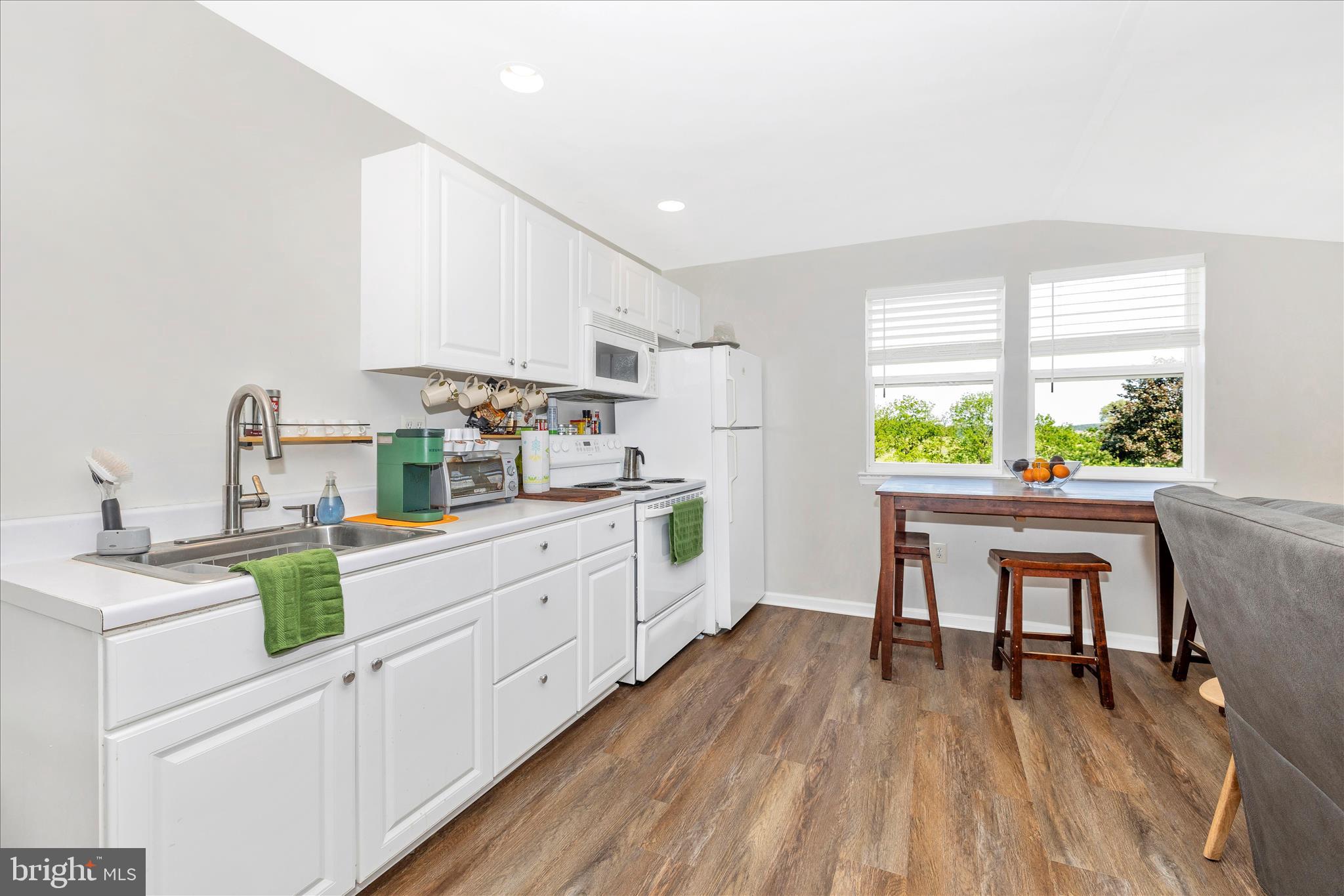 10224 Bessie Clemson Road Union Bridge, MD 21791 - Photo 25 of 46 a kitchen with white cabinets and wooden floor