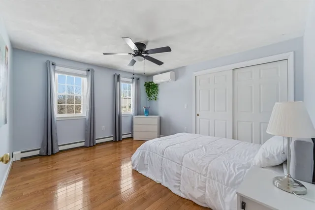 a bedroom with a large bed a chandelier and window