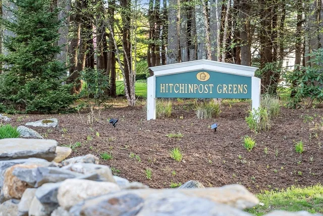 a sign that is sitting on a rock