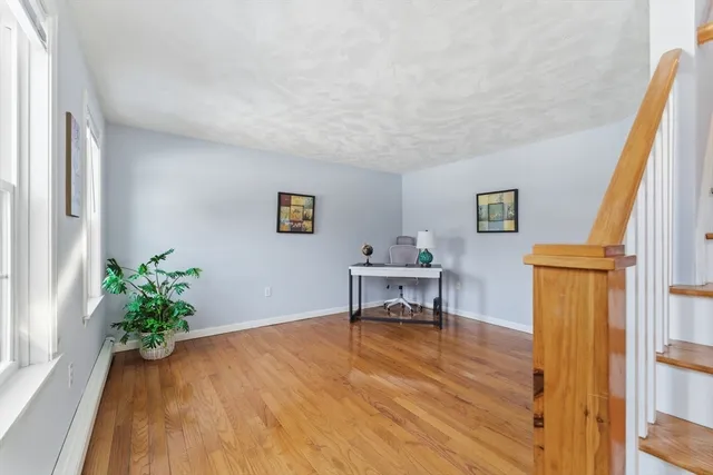 a view of a workspace with furniture and wooden floor