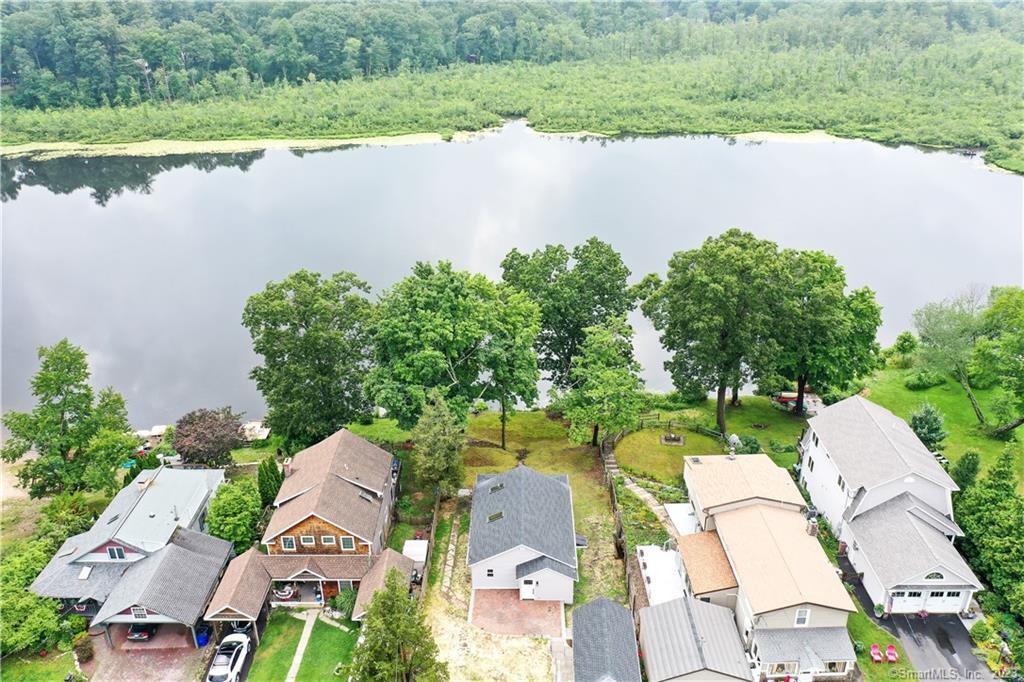 an aerial view of a house with a lake view