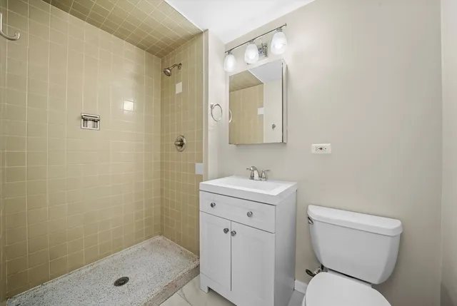 a bathroom with a toilet sink shower and mirror
