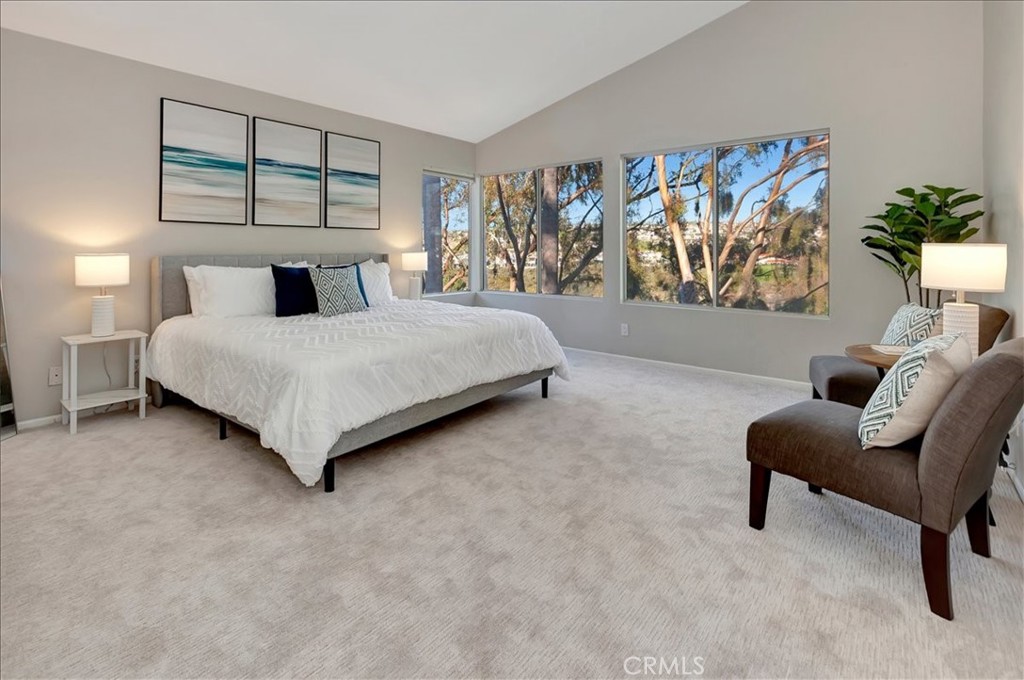 26 Imperatrice Dana Point, CA 92629 - Photo 17 of 58 a spacious bedroom with a bed and a couch