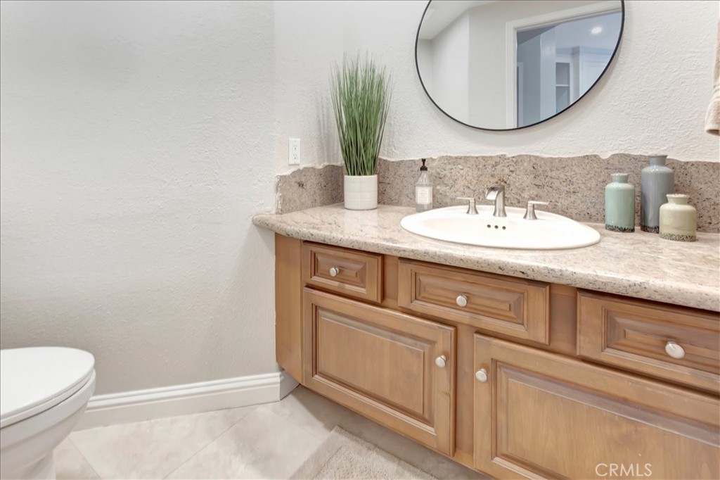 26 Imperatrice Dana Point, CA 92629 - Photo 24 of 58 a bathroom with a granite countertop sink and a mirror