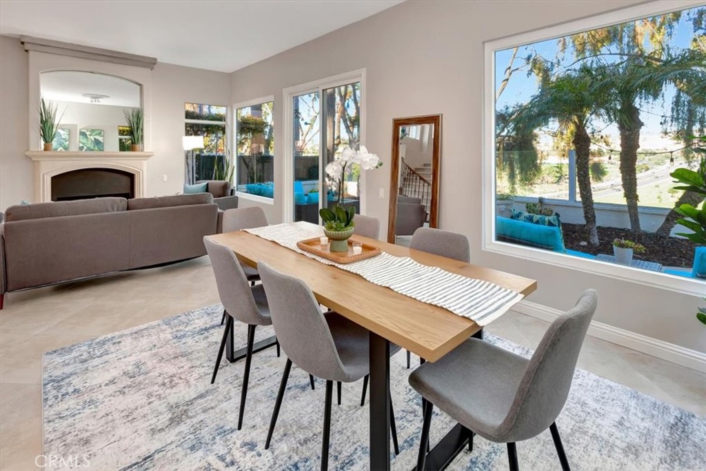 26 Imperatrice Dana Point, CA 92629 - Photo 9 of 58 a view of a dining room with furniture large windows and wooden floor