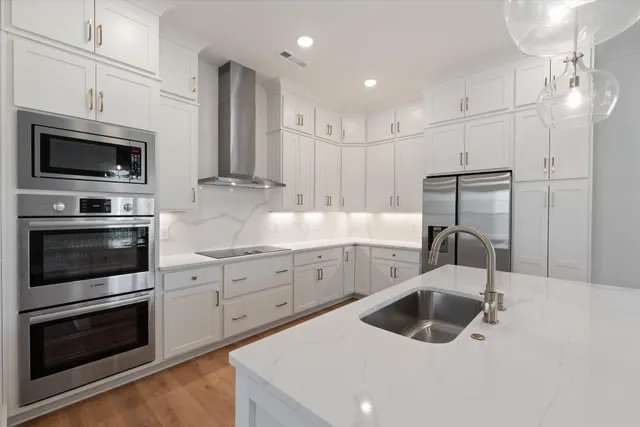 a kitchen with a sink stove and microwave