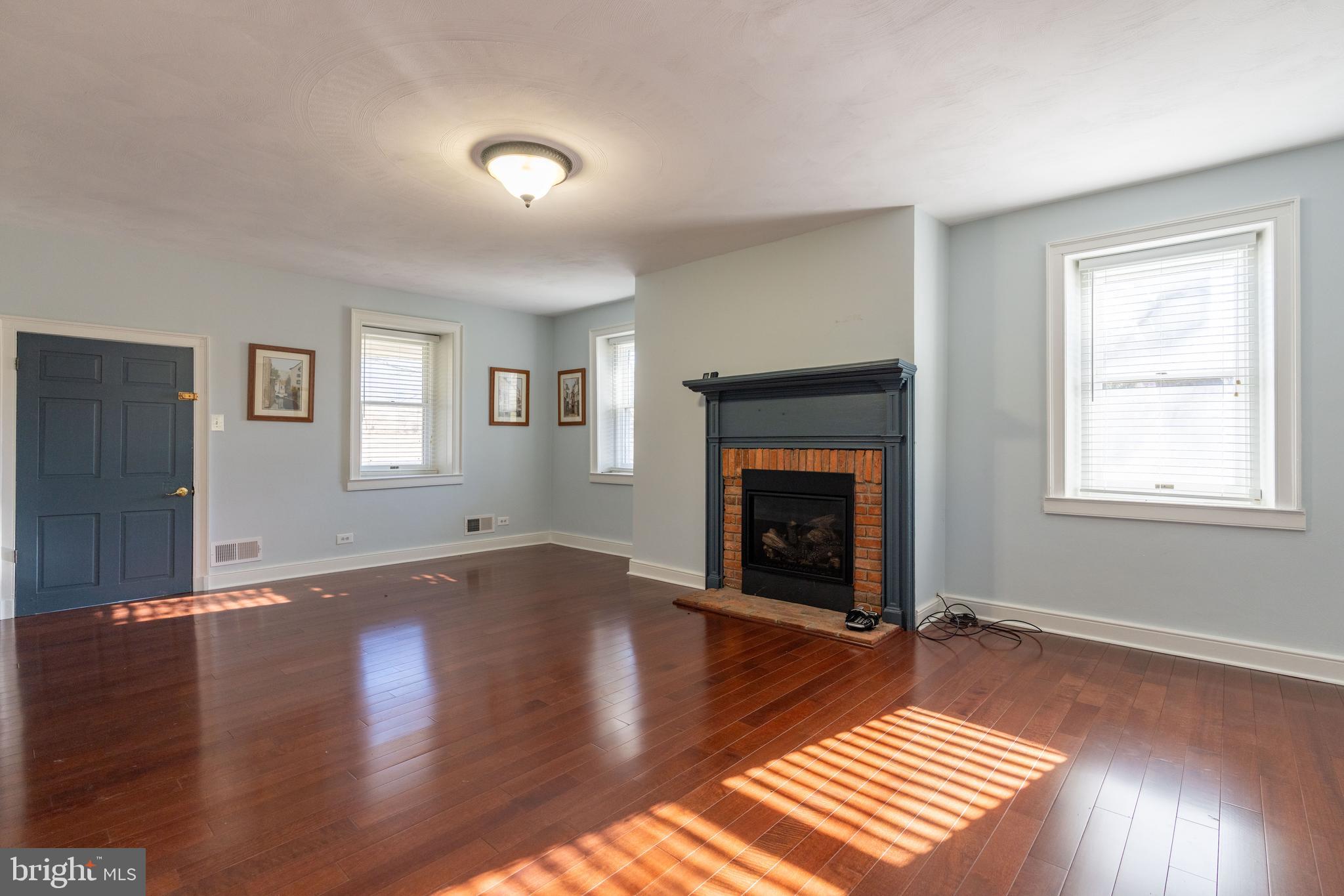 1603 Messiah Church Road Bedford, PA 15522 - Photo 23 of 114 a view of an empty room with wooden floor fireplace and a window