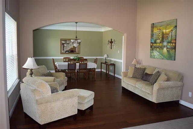 a living room with furniture and a chandelier