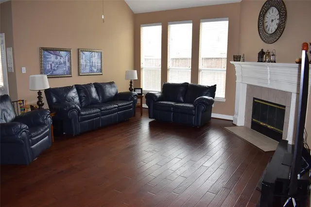 a living room with furniture a large window and a fireplace