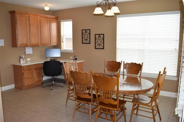 a view of a dining room with furniture and chandelier