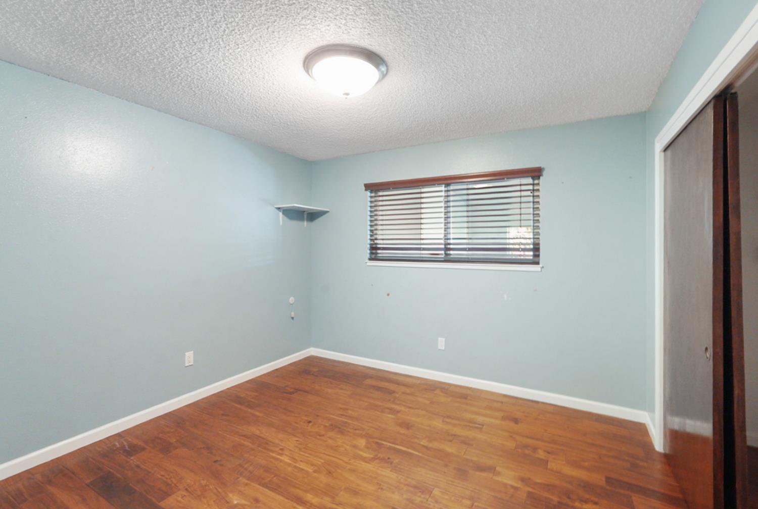 728 R Street Newman, CA 95360 - Photo 11 of 14 an empty room with a window