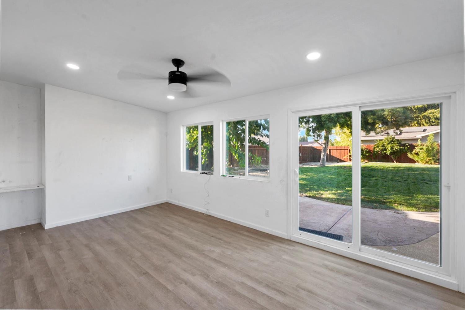 728 R Street Newman, CA 95360 - Photo 13 of 14 a view of an empty room with wooden floor and a window